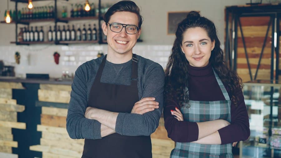 Two cafe owners standing in their cafe
